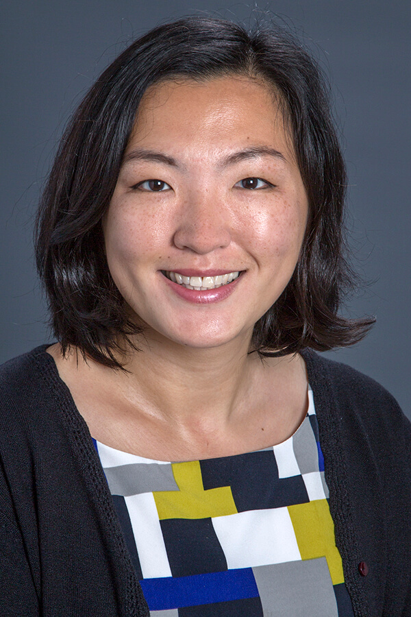 Headshot of Cynthia Wu, MD - woman with black hair wearing a printed top with a grey background