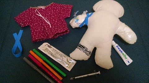  A doll and materials radiology nurses and Child Life specialists typically use in medical play to help prepare kids for an IV placement.